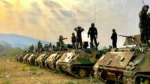 soldiers on top of battle tanks