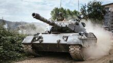 battle tank on green grass field during daytime