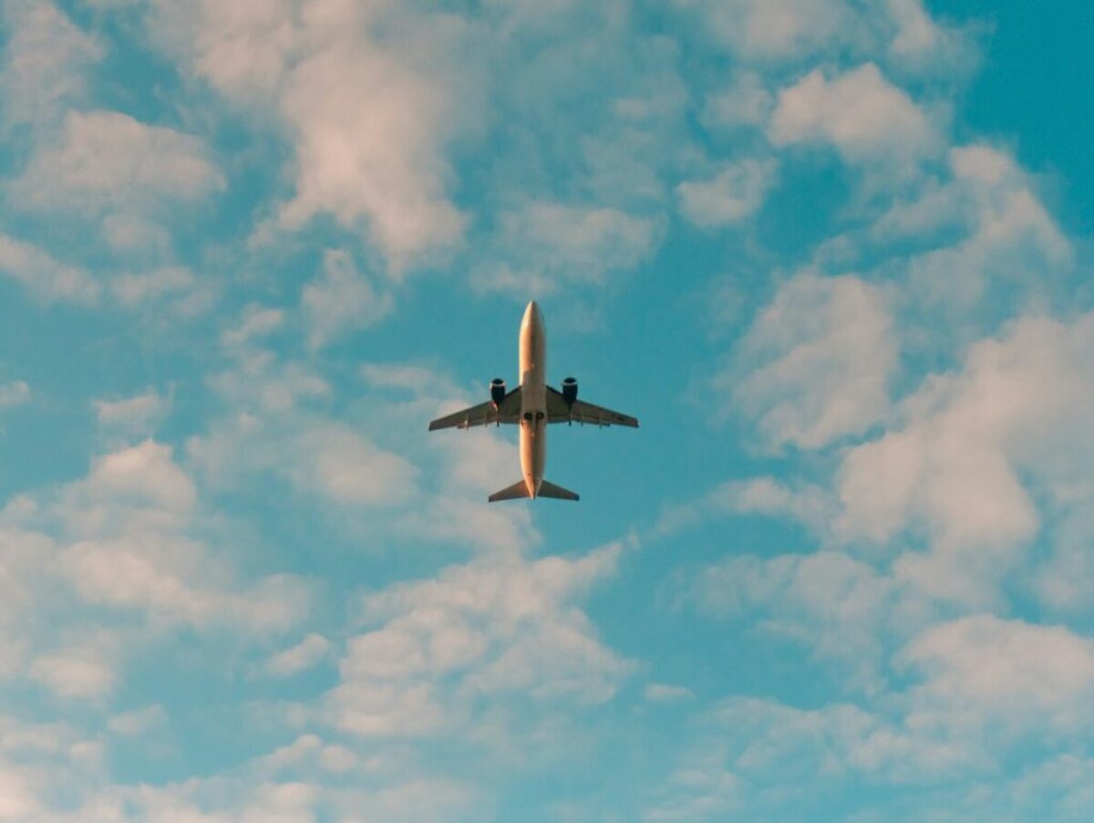 white airplane flying in the sky during daytime