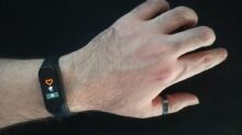person wearing black and silver ring