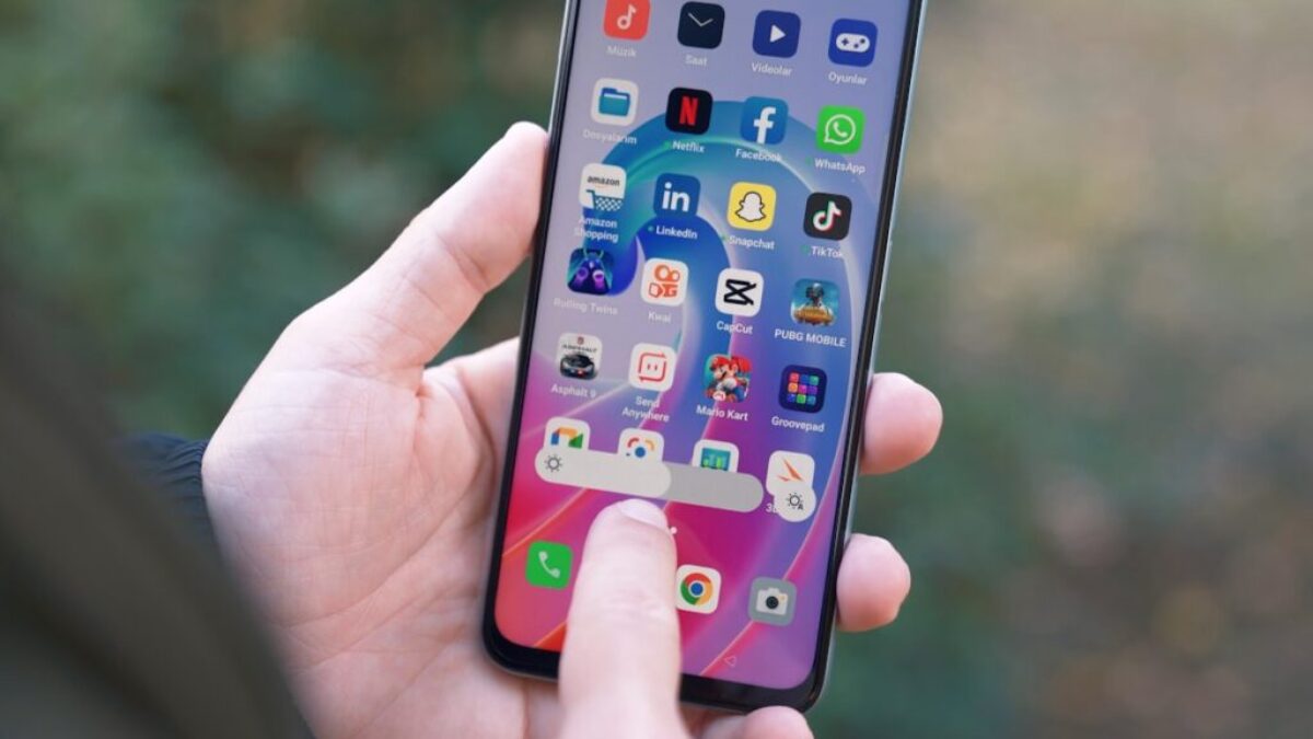 a person holding a cell phone in their hand