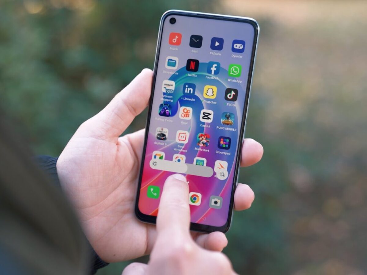 a person holding a cell phone in their hand