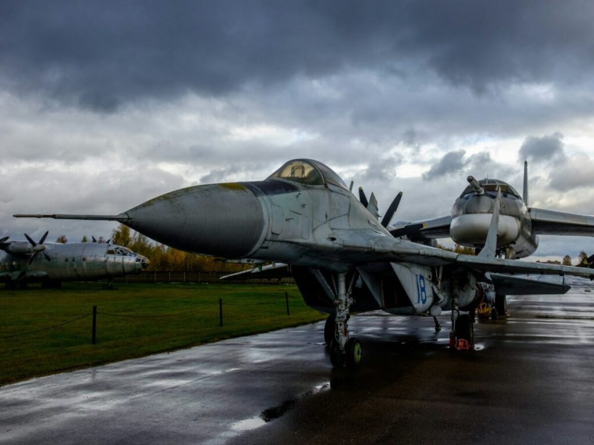 a fighter jet sitting on top of an airport tarmac