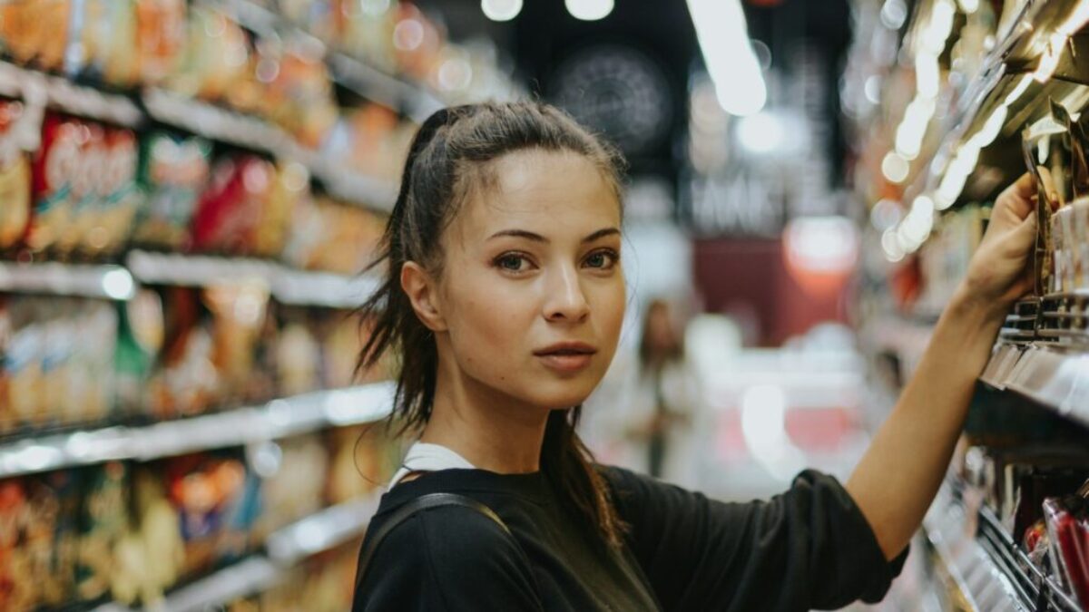 woman selecting packed food on gondola