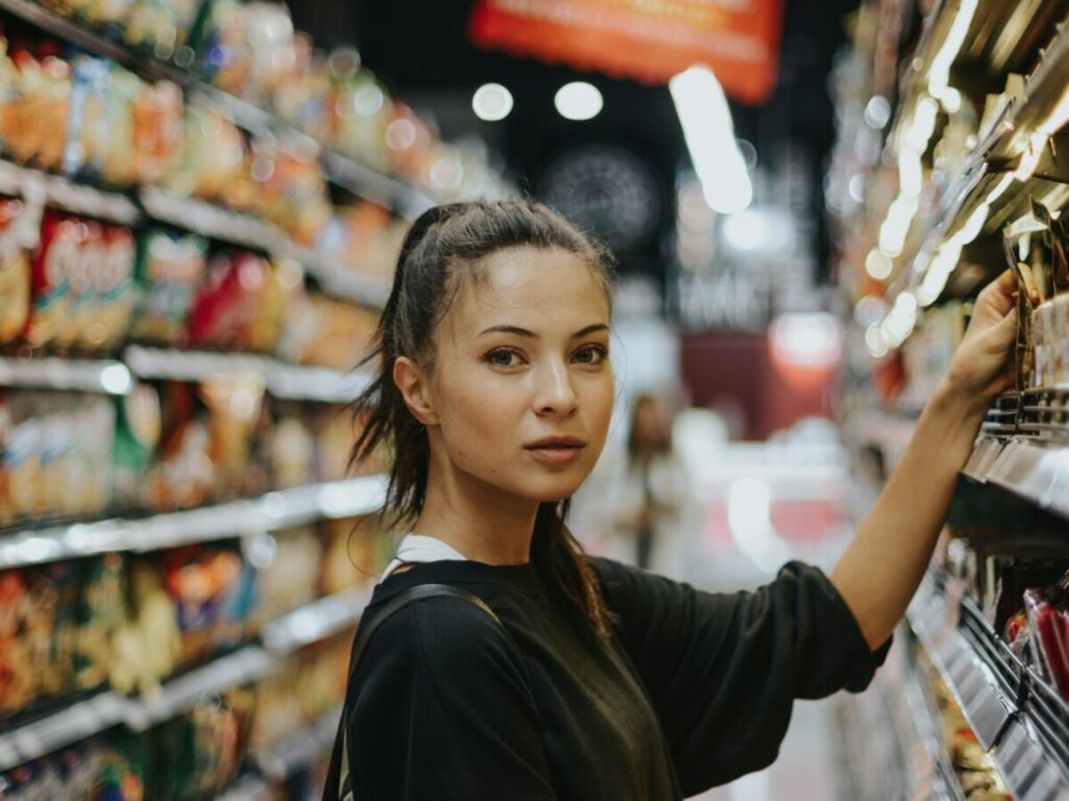 woman selecting packed food on gondola