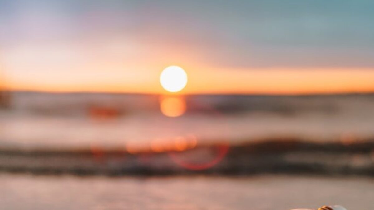 clear glass mason jar on beach during sunset