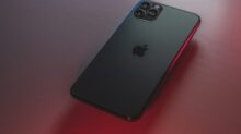 black iphone 7 plus on red table