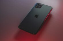 black iphone 7 plus on red table