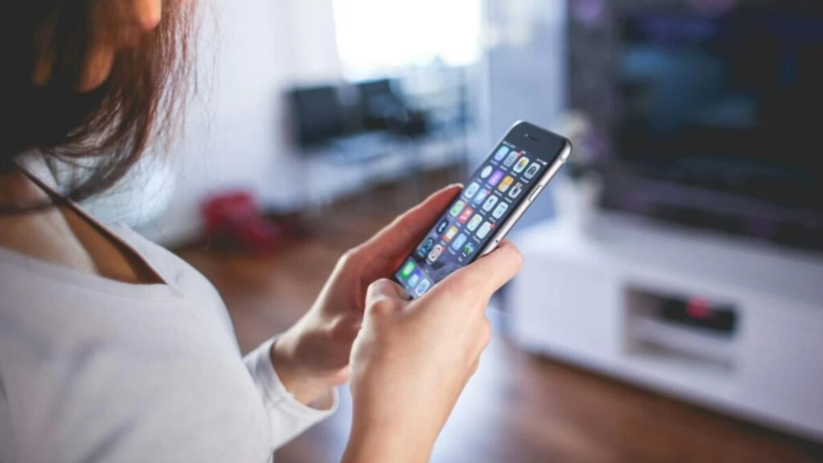 Woman Wearing White V Neck Shirt Using Space Gray Iphone 6