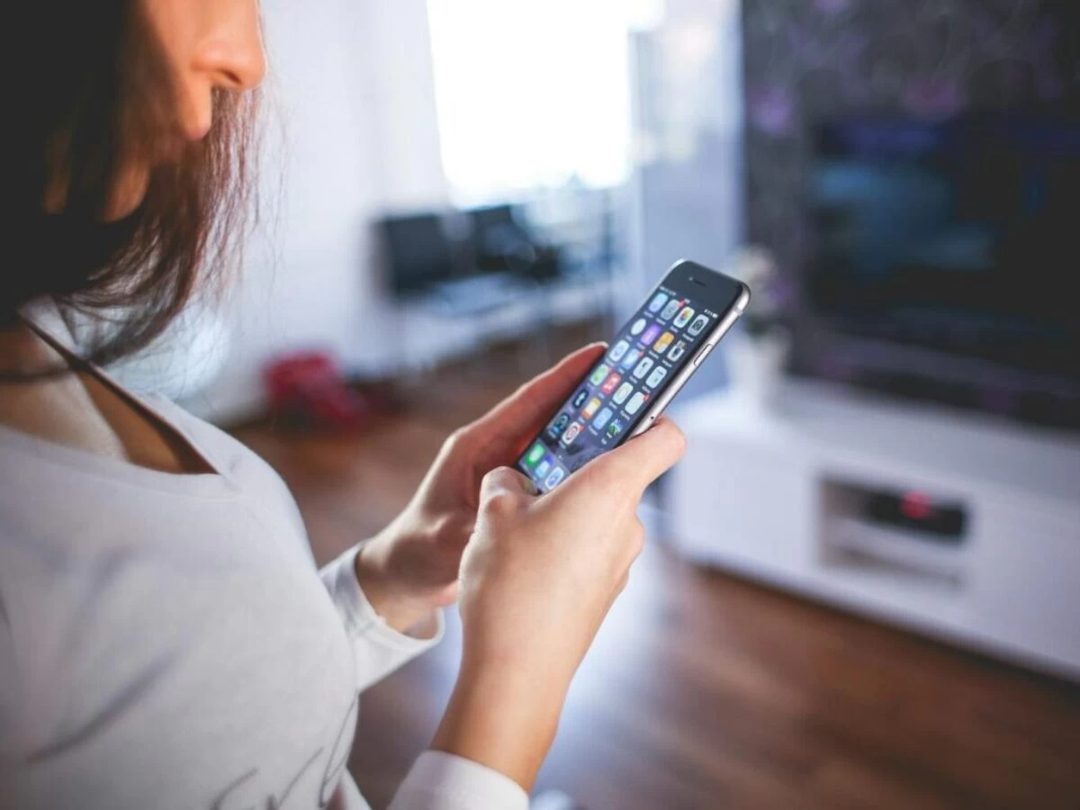 Woman Wearing White V Neck Shirt Using Space Gray Iphone 6