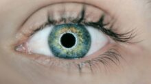 person showing green and black eyelid closeup photography