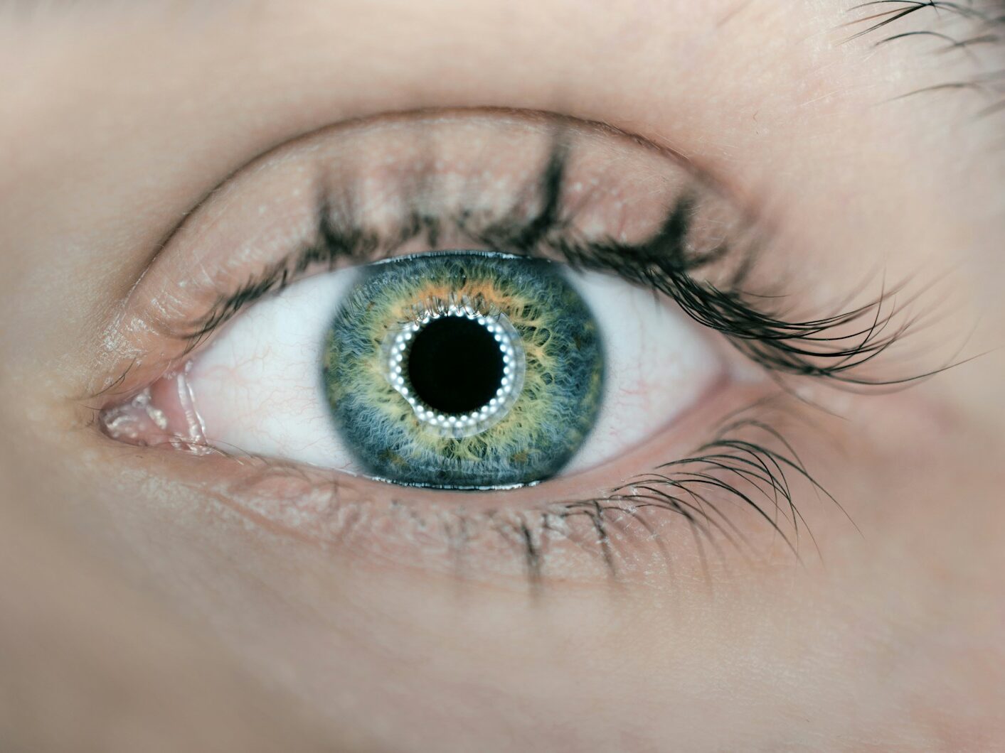 person showing green and black eyelid closeup photography