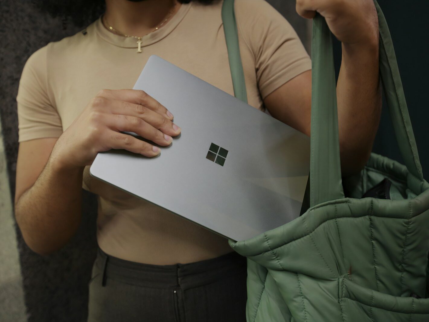 Female putting her Surface laptop in her bag