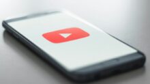 a close up of a cell phone with a youtube logo on it