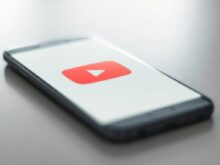 a close up of a cell phone with a youtube logo on it
