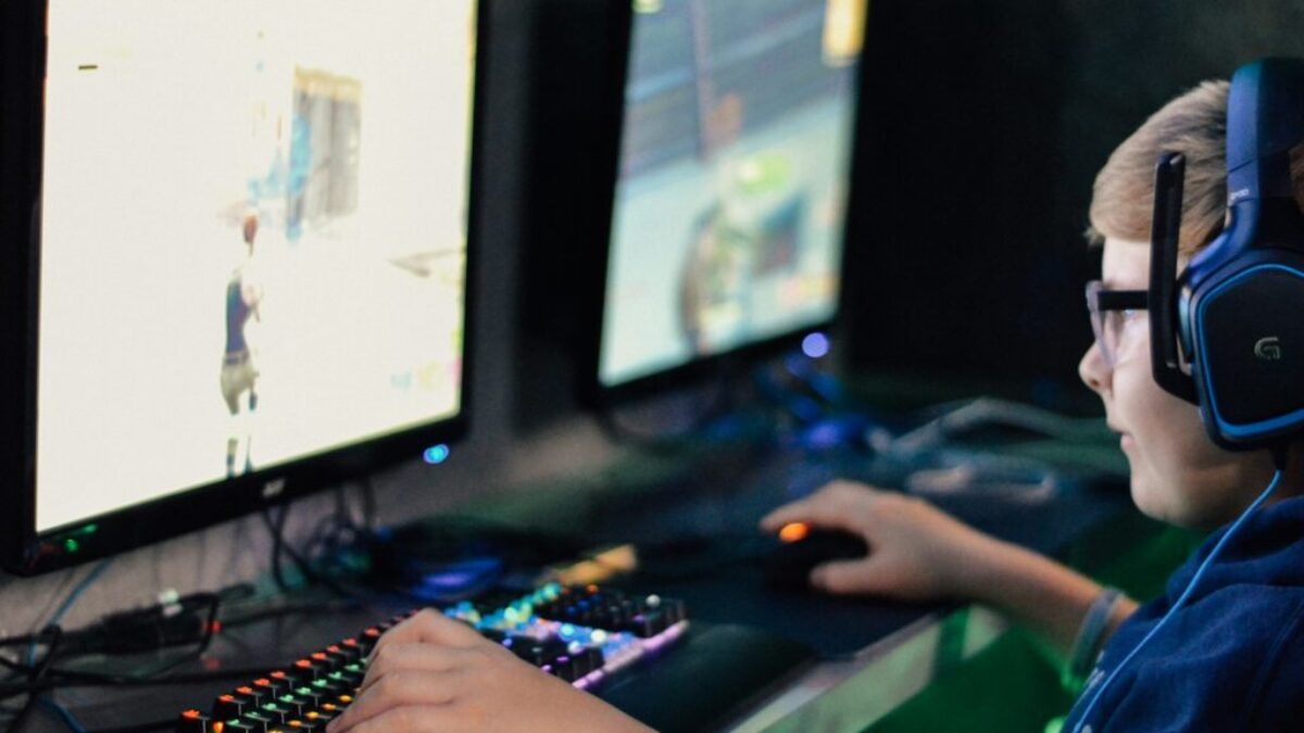 boy wearing headset playing computer game