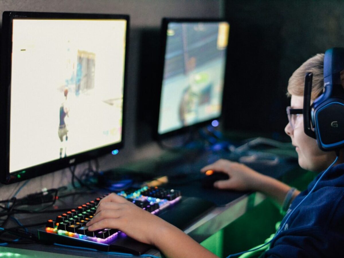 boy wearing headset playing computer game