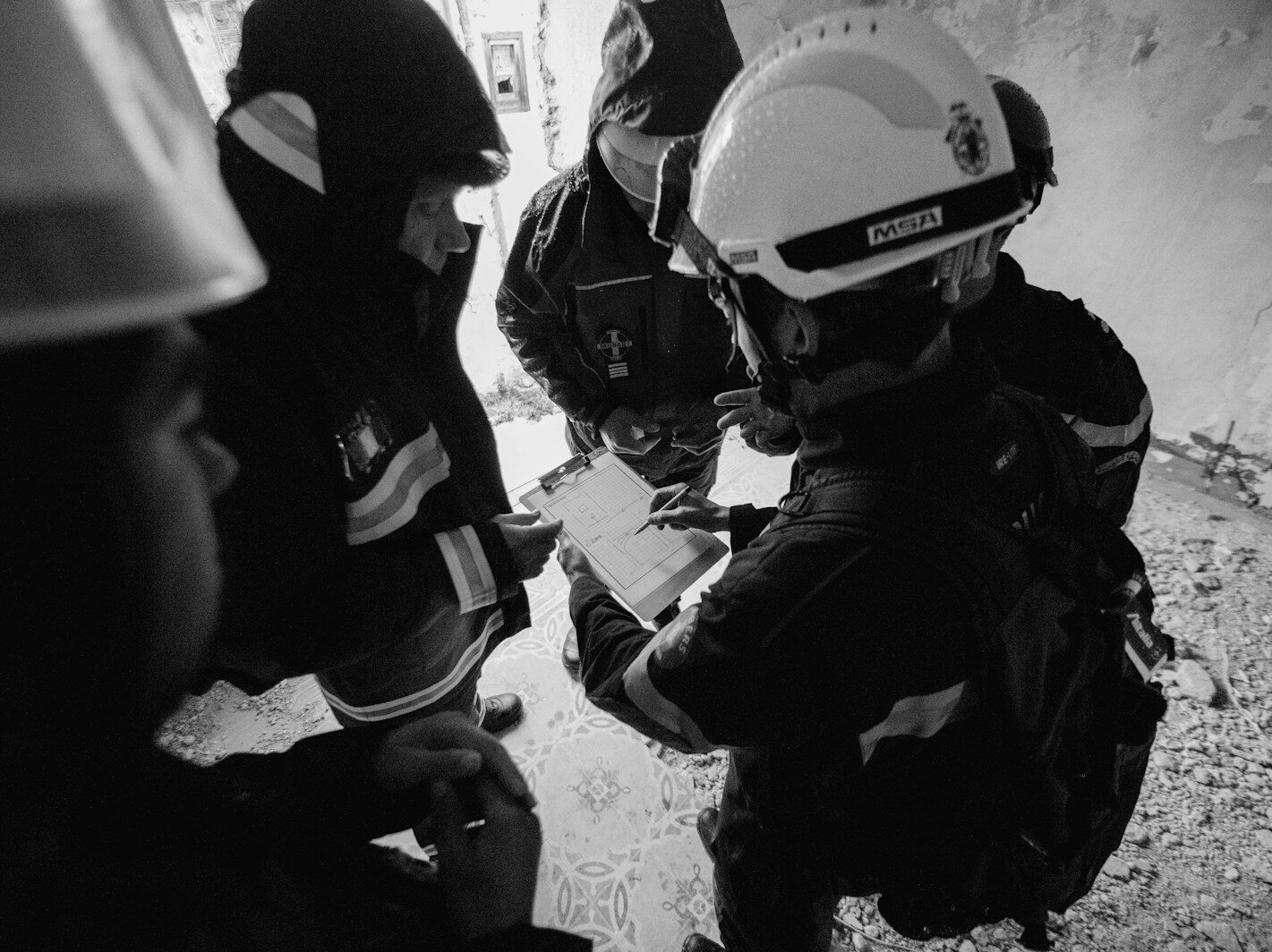 grayscale photo of 2 men in black jacket and helmet