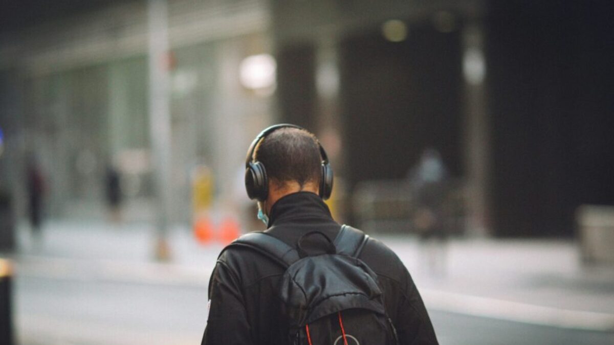 man in black jacket wearing black headphones