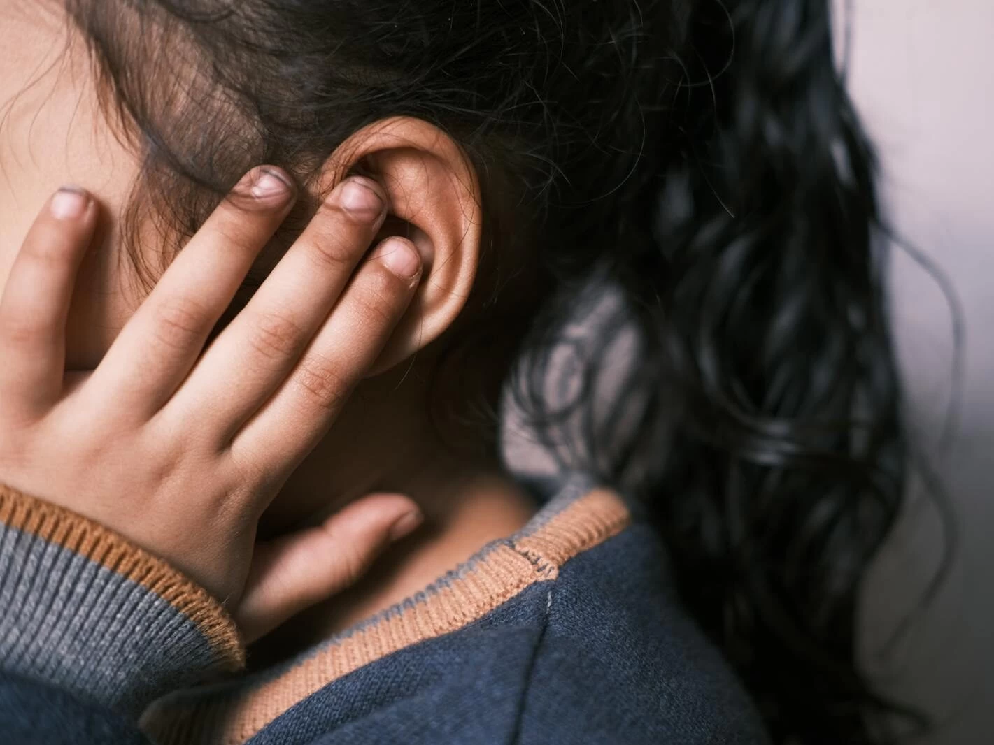 Girl Covering Ear