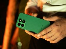 Close-up of a Man Holding a Green Smartphone