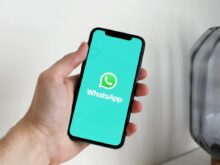 A Person Holding a Cellphone with Logo on the Screen