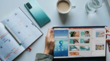 person using Windows 11 computer beside white ceramic mug on white table