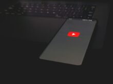 black laptop computer turned on with red light