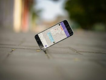 selective focus photo of iPhone balance on brick pavement