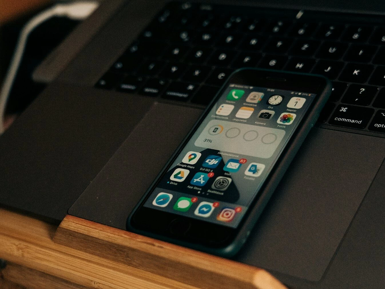 black iphone 4 on black laptop computer