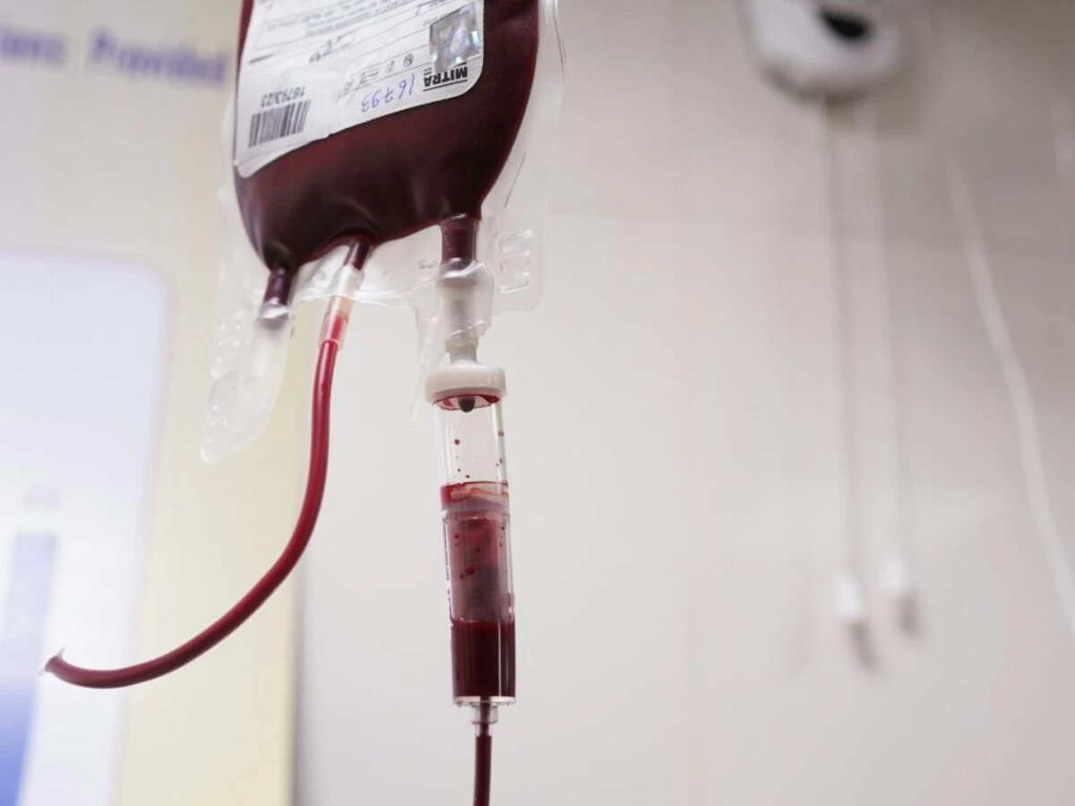 a blood test tube with a blood dropper attached to it