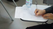 a person writing on a piece of paper