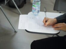 a person writing on a piece of paper
