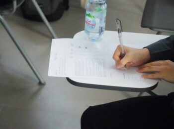a person writing on a piece of paper