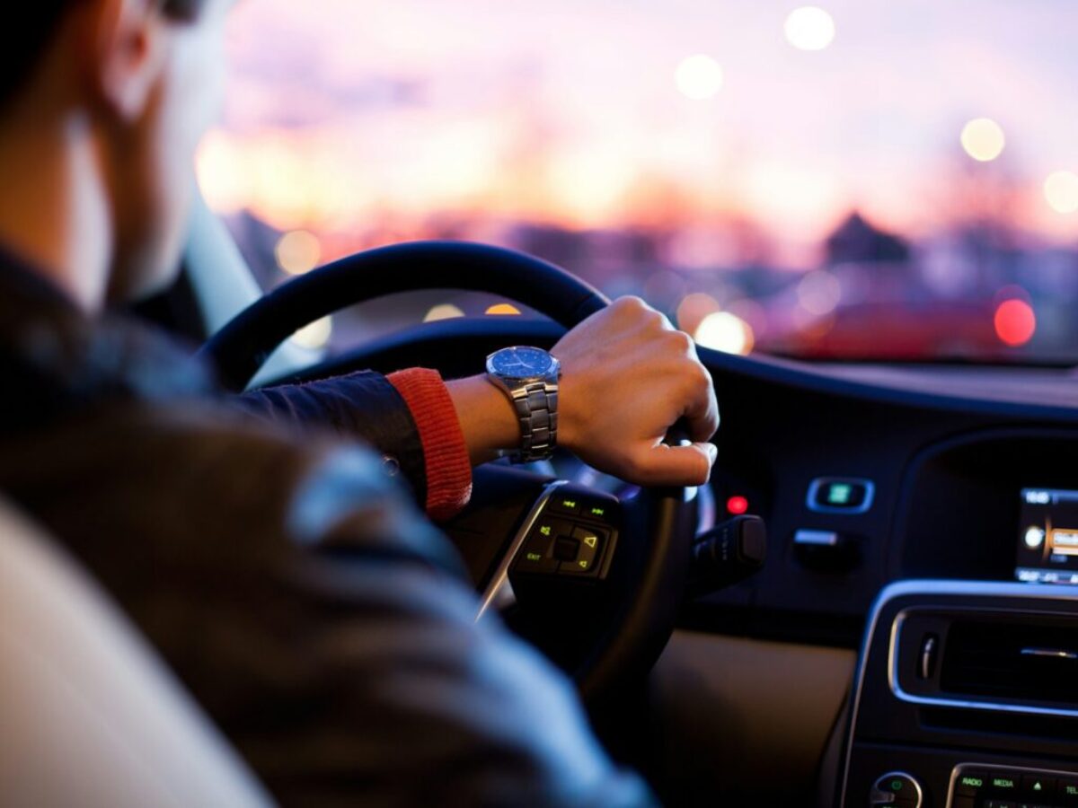 man driving a car wearing wrist watch
