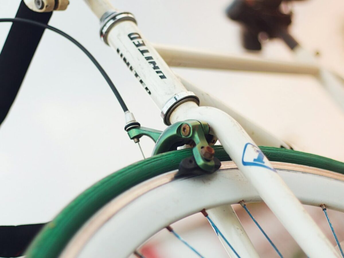 white and green bicycle with green handle bar