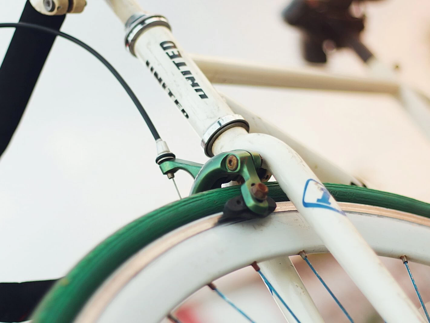 white and green bicycle with green handle bar