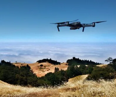 Ian Usher black drone on air over cloudy sky at daytime