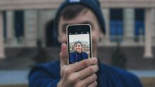 man taking photo near building