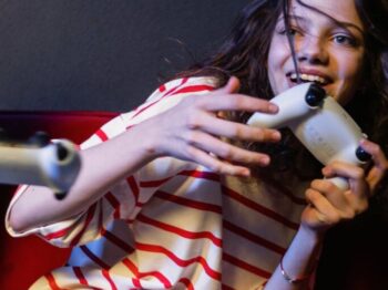 A Woman in Striped Shirt Holding a Game Controller