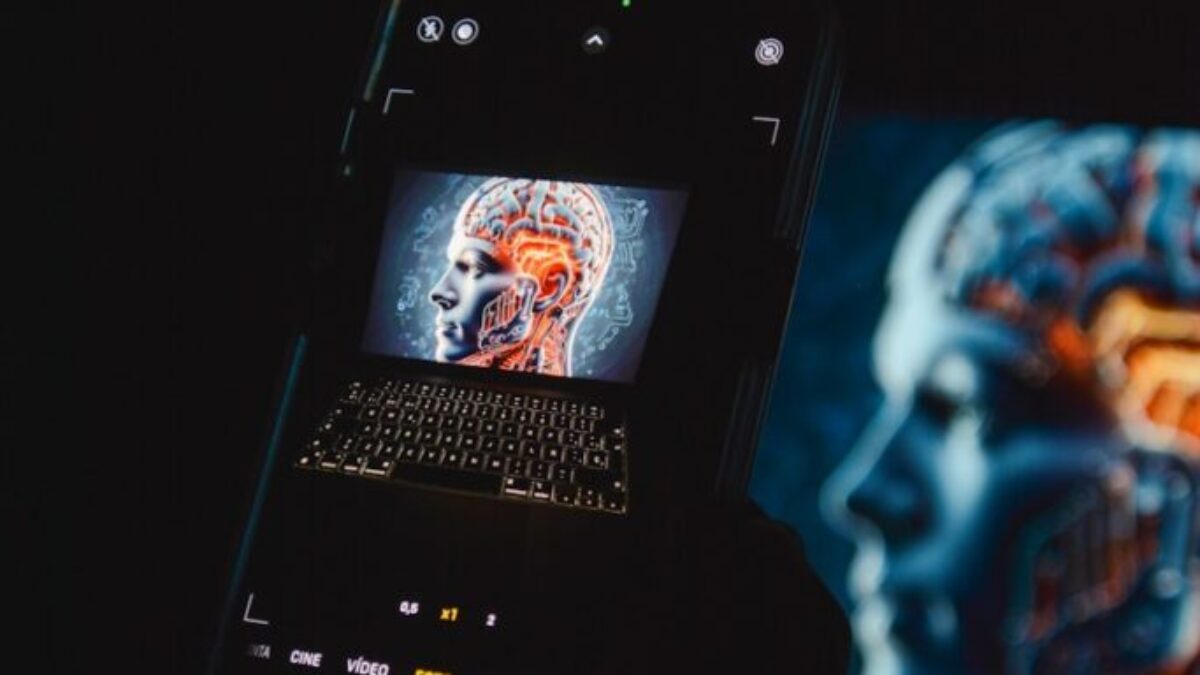 a cell phone sitting on top of a laptop computer