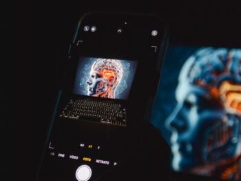 a cell phone sitting on top of a laptop computer