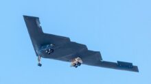 black jet plane in mid air during daytime