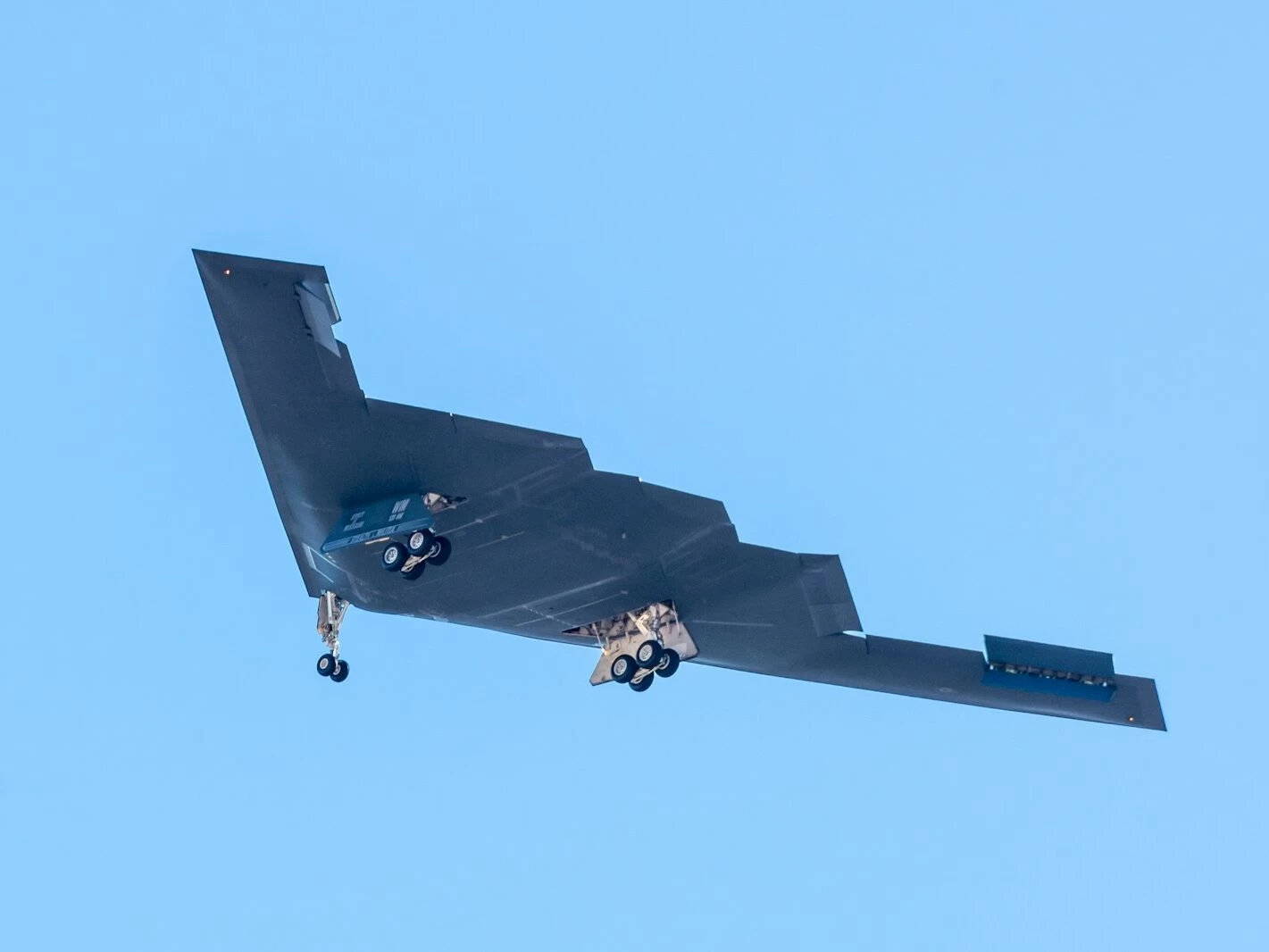 black jet plane in mid air during daytime