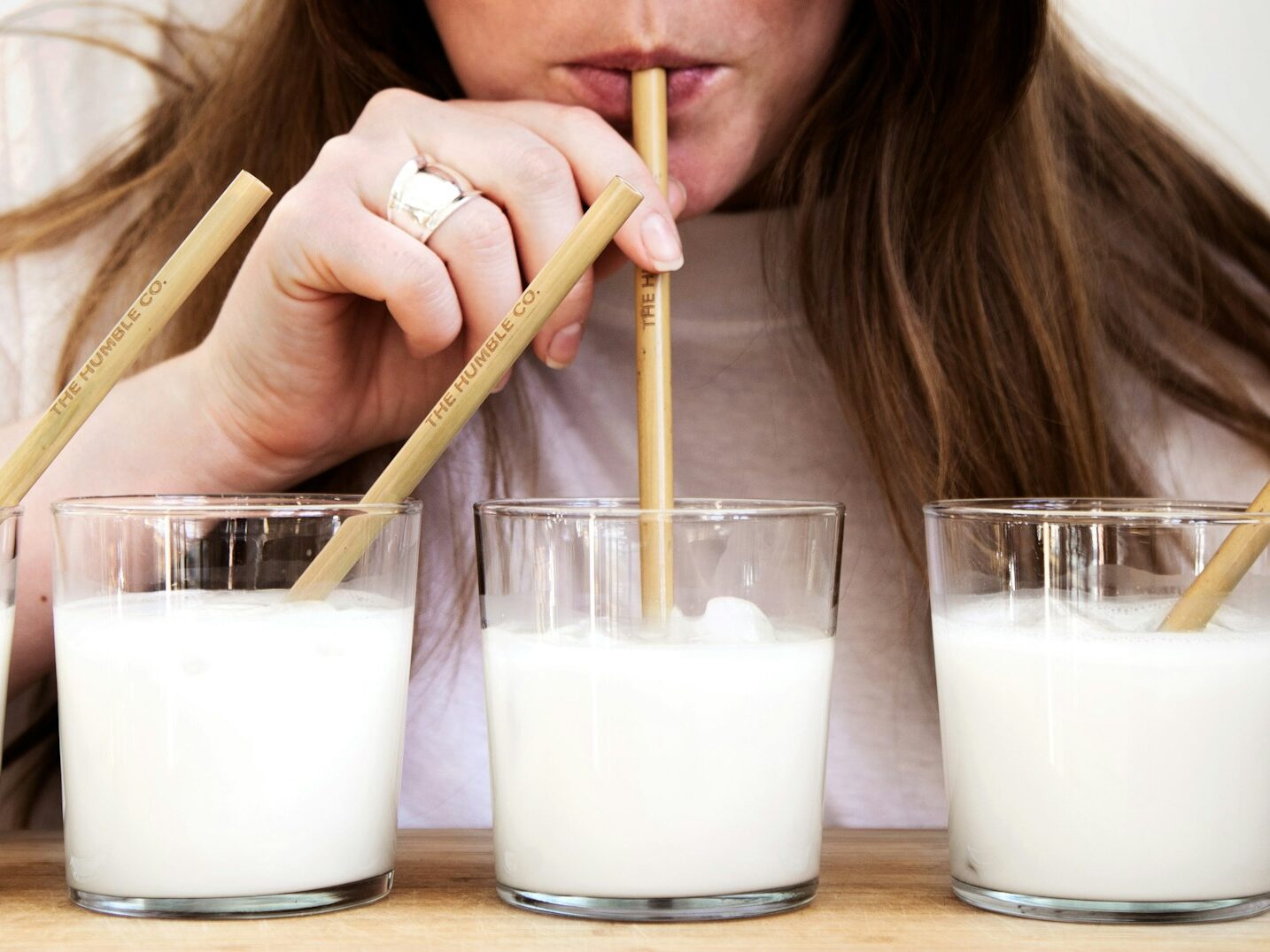 woman holding brown wooden chopsticks