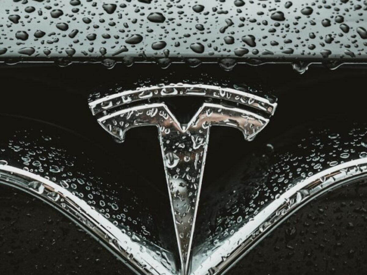 a close up of a car's emblem on a wet surface