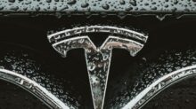 a close up of a car's emblem on a wet surface