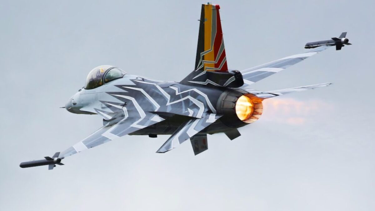 a fighter jet flying through a cloudy sky