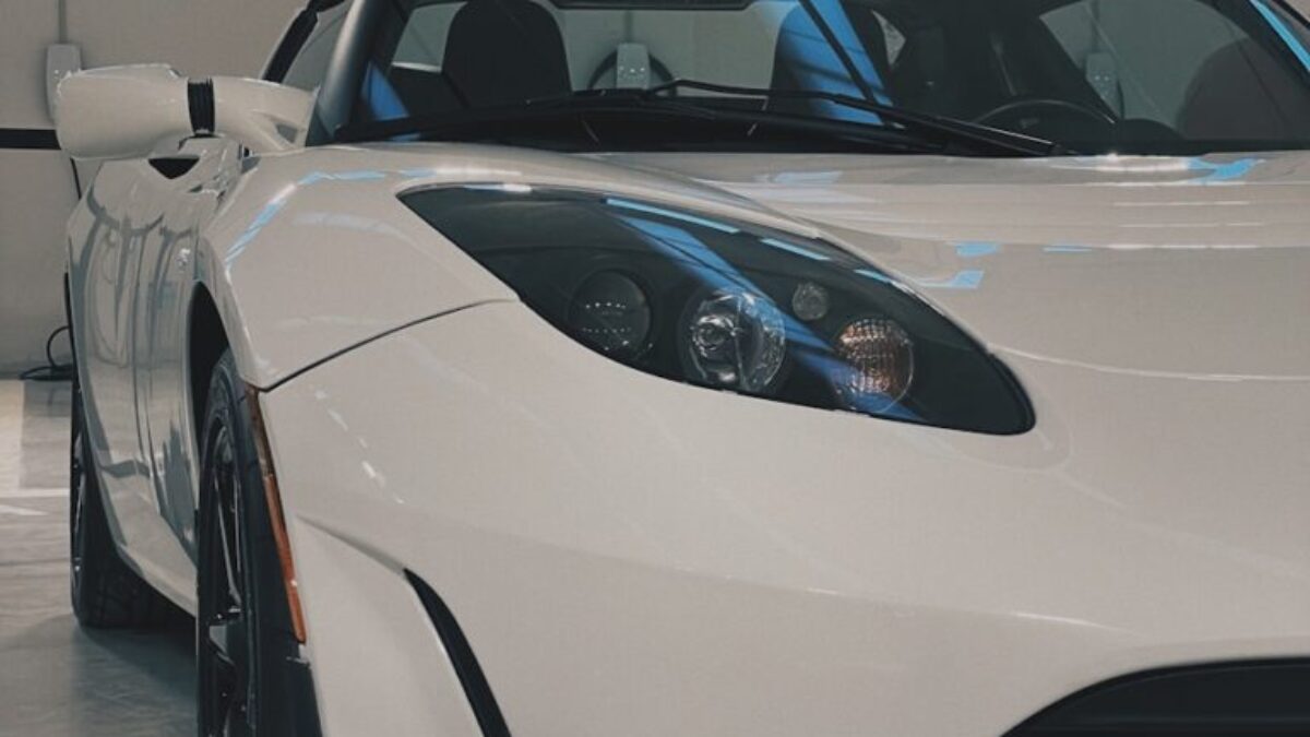 a white sports car parked in a garage
