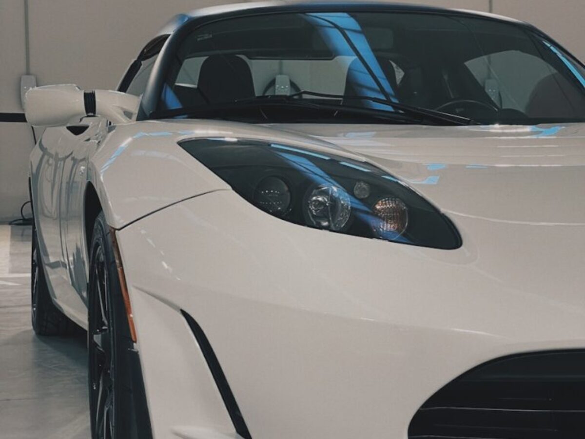 a white sports car parked in a garage